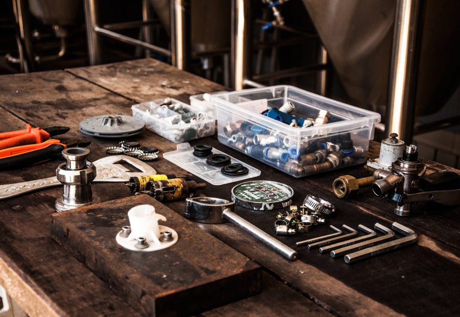 Fittings and small parts sorted into a tray on a workbench